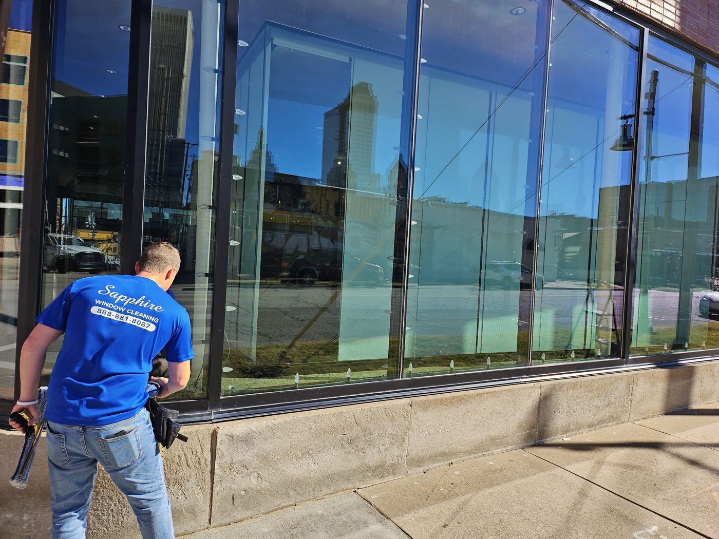 a technician cleaning a storefront